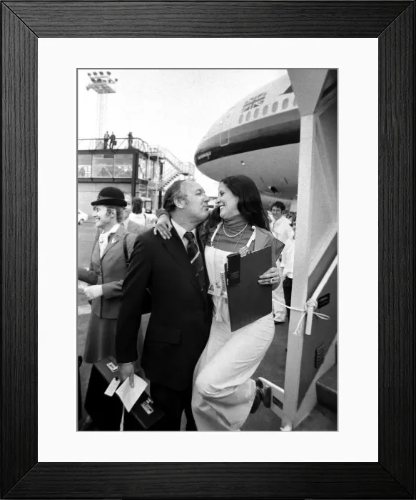 Framed Print : Freddie Laker kisses a Gatwick hostess goodbye before she boards the Sky train Framed Print : Freddie Laker kisses a Gatwick hostess goodbye before she boards the Sky train