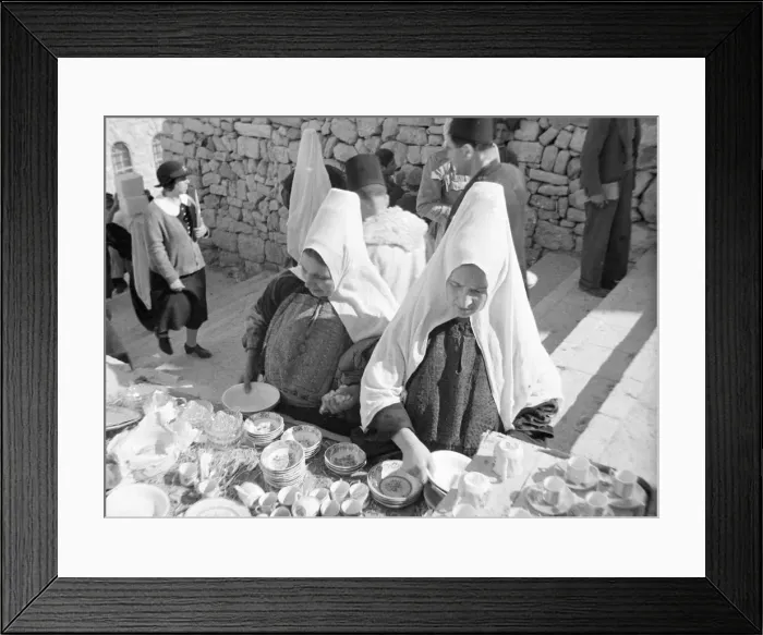 Framed Print : Women inspects crockery in the market in Bethlehem Circa 1935