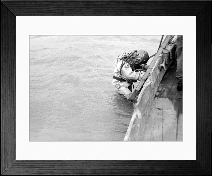 Framed Print : A diver wearing protective equipment goes down into the water at a Naval diving school in Framed Print : A diver wearing protective equipment goes down into the water at a Naval diving school in