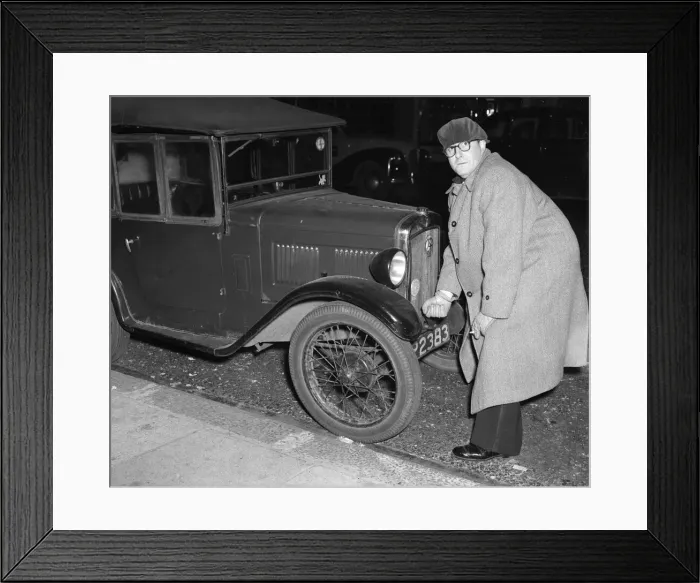 Framed Print : Actor Peter Sellers seen here trying to start his Austin 7 motor car outside the Paris Framed Print : Actor Peter Sellers seen here trying to start his Austin 7 motor car outside the Paris
