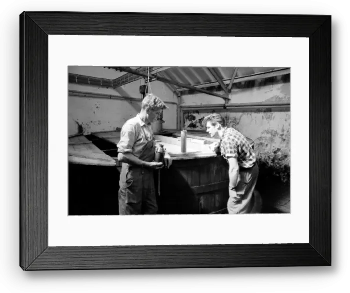 Framed Print : Workers inspect the malt grist in the Mash tun at the Knockando Whisky Distillery Framed Print : Workers inspect the malt grist in the Mash tun at the Knockando Whisky Distillery