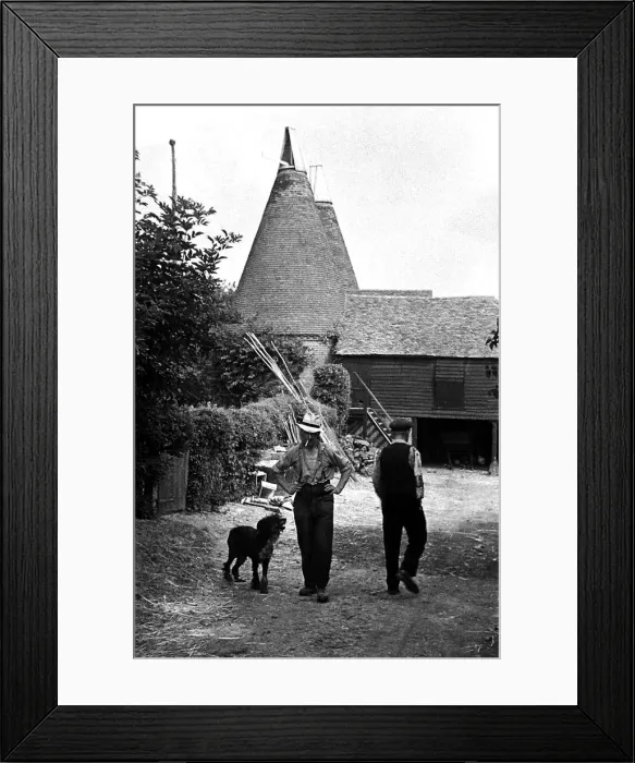 Framed Print : Two workers pass each other on a farm, circa 1938 Framed Print : Two workers pass each other on a farm, circa 1938