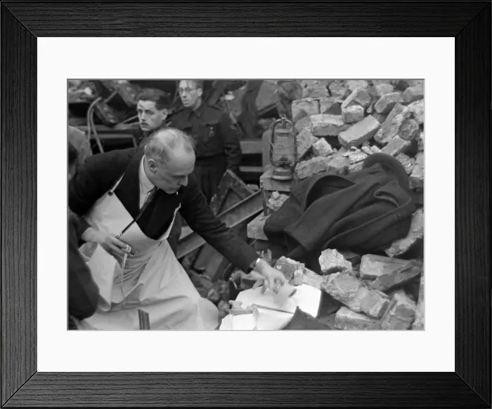 Framed Print : A doctor prepares his instruments while rescue workers search the rubble following Framed Print : A doctor prepares his instruments while rescue workers search the rubble following