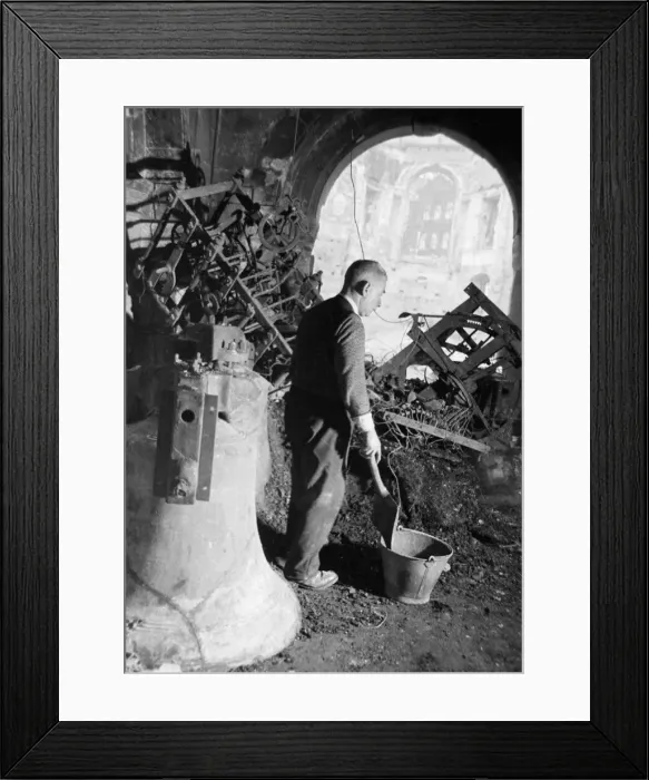 Framed Print : A member of the congregation digs through the remains of the belfry of St Clements Dane Framed Print : A member of the congregation digs through the remains of the belfry of St Clements Dane