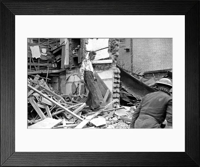 Framed Print : A man wades through the debris of bomb damage in Kings Cross after air raids