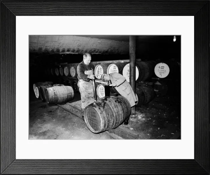 Framed Print : Barrels being tested in the bonded warehouse at the Knockando Whisky Distillery, Moray