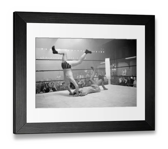 Framed Print : Wrestler jackie Pallo is thrown head over heels by Gigi Gattri during the filming of