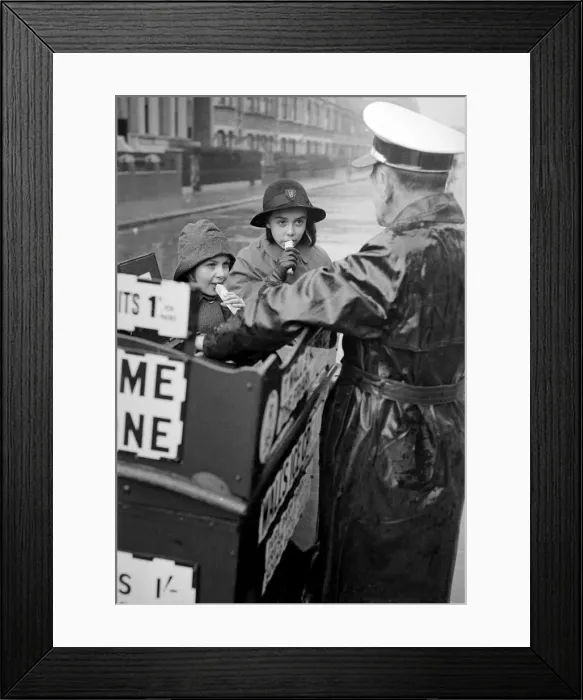 Framed Print : Walls Ice Cream man seen here on his tricycle serving two schoolgirls Circa Framed Print : Walls Ice Cream man seen here on his tricycle serving two schoolgirls Circa