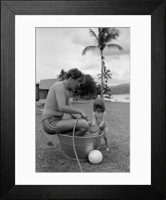 Framed Print : Comedian, actor and publisher Peter Cook with his daughter Lucy during a holiday in