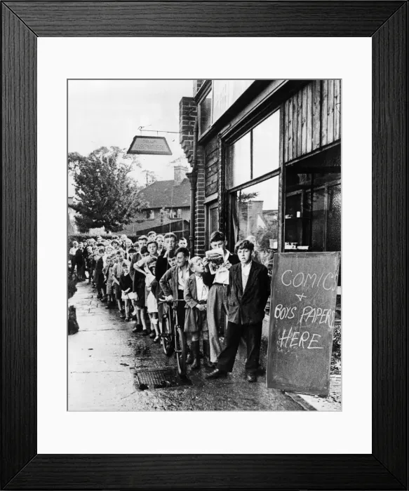 Framed Print : Children queue up outside a shop for comics in Eltham, London during World War Two Framed Print : Children queue up outside a shop for comics in Eltham, London during World War Two