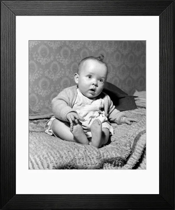 Framed Print : Seven month old baby girl Rosanna sitting on a bed at home March 1959 Framed Print : Seven month old baby girl Rosanna sitting on a bed at home March 1959