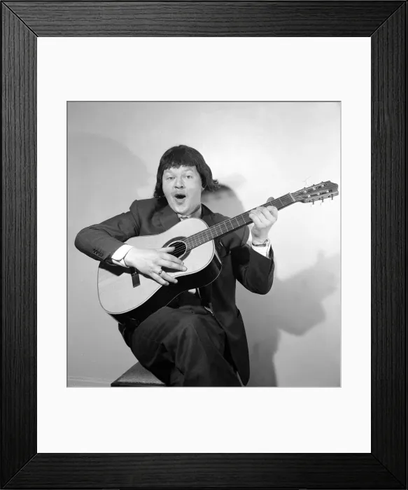 Framed Print : Comedian Benny Hill pictured at home wearing a wig and playing the guitar May 1958 Framed Print : Comedian Benny Hill pictured at home wearing a wig and playing the guitar May 1958