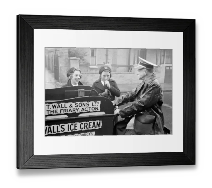 Framed Print : Walls Ice Cream man seen here on his tricycle serving two schoolgirls Circa