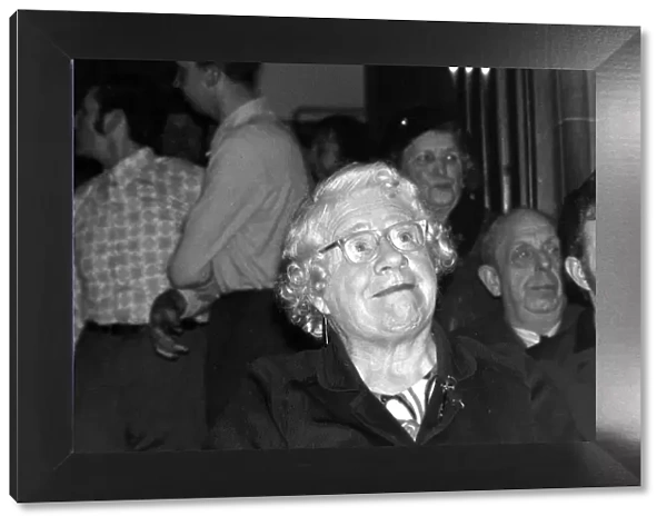 A old lady in the audience cheers on the wrestlers at the Chester Town hall