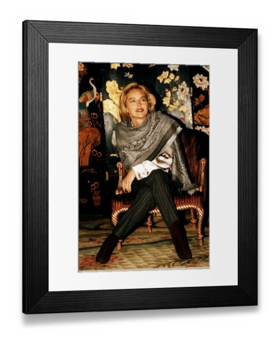 Framed Print : Sharon Stone actress Sitting on a chair, legs crossed, wearing a scarf Framed Print : Sharon Stone actress Sitting on a chair, legs crossed, wearing a scarf