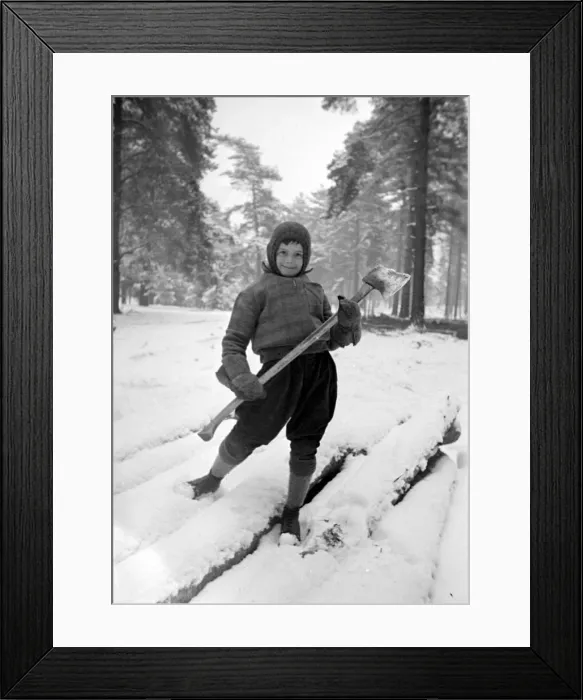 Framed Print : A young lumberjack at work in the snow Circa 1943 Framed Print : A young lumberjack at work in the snow Circa 1943