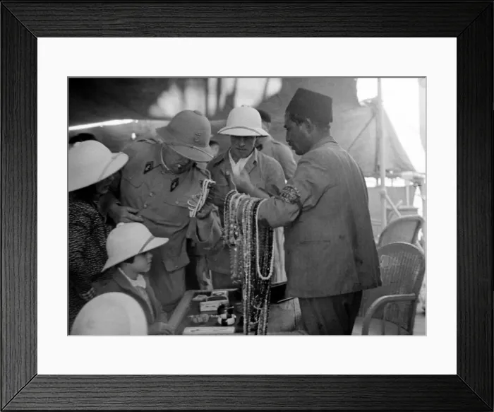 Framed Print : European looking at beads and jewellery for sale in a shop in Somaliland Circa 1935 Framed Print : European looking at beads and jewellery for sale in a shop in Somaliland Circa 1935