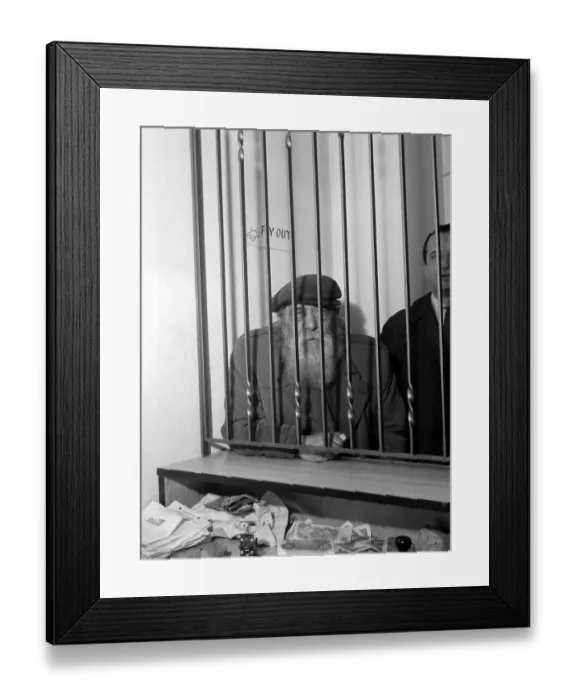 Framed Print : An elderly man waits in line to place a bet at a busy betting shop in Soho