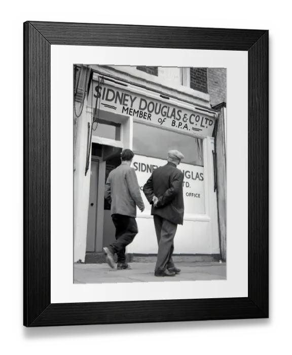 Framed Print : Two men walking past Sidney Douglas betting shop in Mile End Road London May 1961