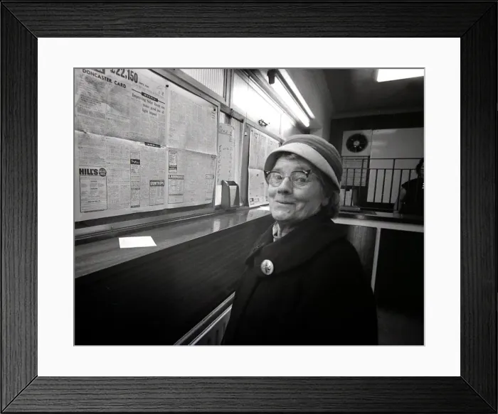 Framed Print : 72 year old lady Lottie Benger pops in to a Ladies only betting shop in Worcester to