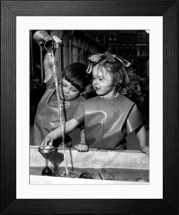 Framed Print : Boy and girl palying with a jug of water and funnel June 1954 Framed Print : Boy and girl palying with a jug of water and funnel June 1954