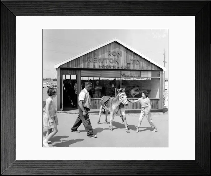 Framed Print : Holidaymakers outside a betting shop in the form of a wooden chalet on the beach Framed Print : Holidaymakers outside a betting shop in the form of a wooden chalet on the beach