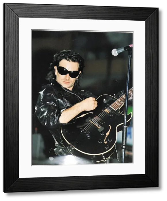 Framed Print : Bono of the pop group U2 performing on stage at Celtic Park in Glasgow during their ZOO
