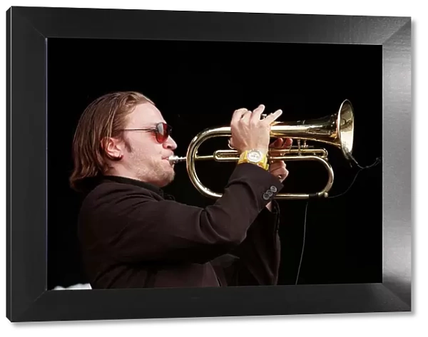 Member of the Fun Loving Criminals on stage playing the trumpet at T in the Park July