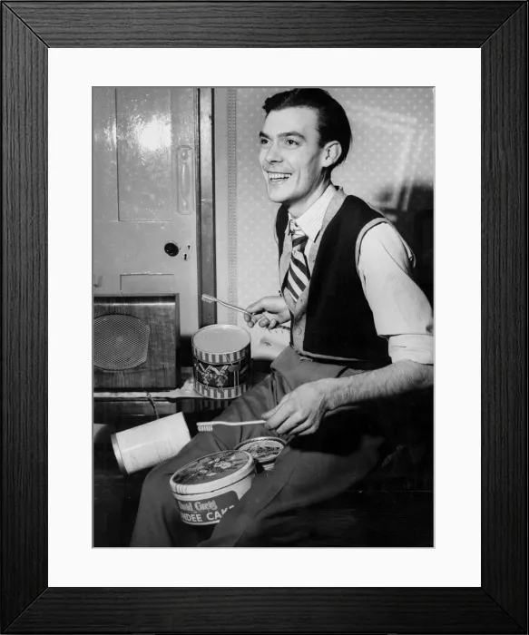 Framed Print : A man playing the drums using toothbrushes for drumsticks