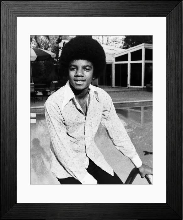 Framed Print : Michael Jackson Singer sitting on the edge of swimming pool circa 1975