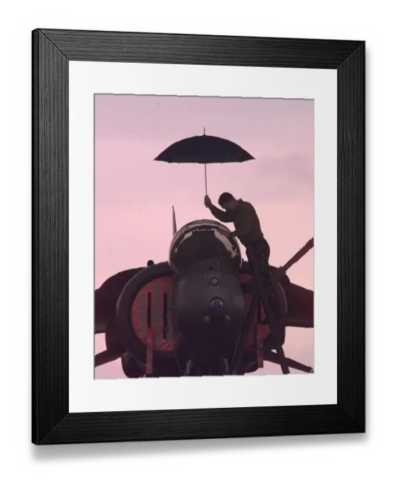 Framed Print : A harrier technician works on a weather grounded harrier at Gioia del Colle air base in