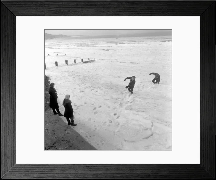 Framed Print : Having fun at the frozen seaside at Herne Bay. A group of young men Framed Print : Having fun at the frozen seaside at Herne Bay. A group of young men