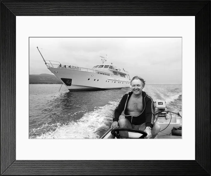 Framed Print : Freddie Laker chairman of Laker Airways July 1981 driving motor boat beside his Framed Print : Freddie Laker chairman of Laker Airways July 1981 driving motor boat beside his