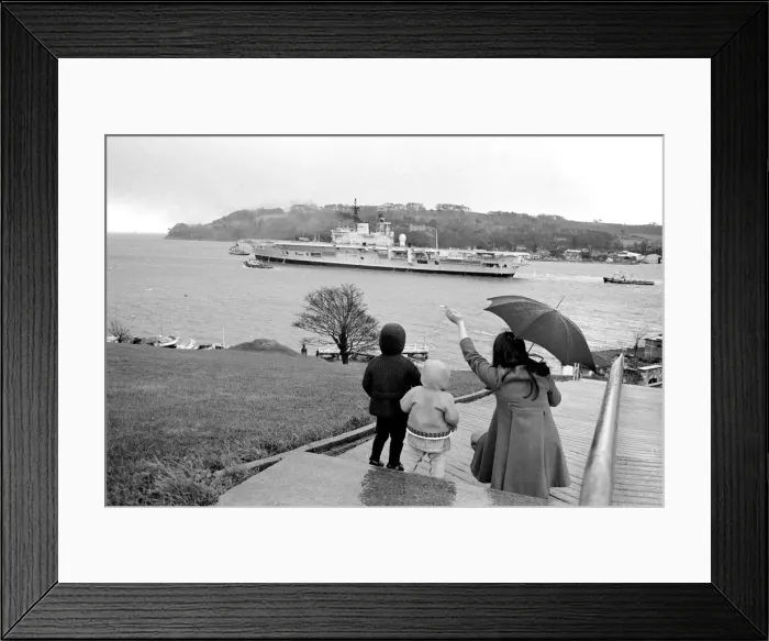 Framed Print : A family stand in the rain as they wave to Aircraft carrier HMS Ark Royal on preliminary Framed Print : A family stand in the rain as they wave to Aircraft carrier HMS Ark Royal on preliminary