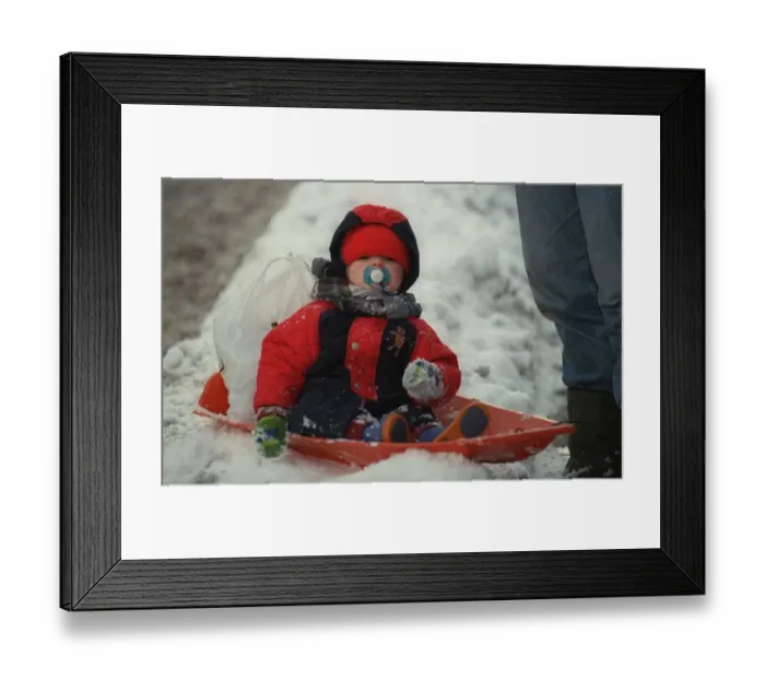 Framed Print : Weather in Aberdeen 9th February 1999 A toddler in Aberdeen shows how to enjoy