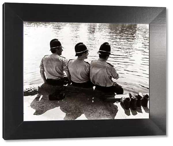 policemen sitting by a river on a hot sunny day... July 1976 summer sun