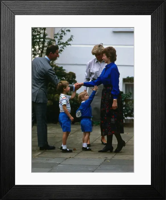 Framed Print : Prince Harry, wearing a blue sweatshirt shorts and Thomas the Tank Engine bag Framed Print : Prince Harry, wearing a blue sweatshirt shorts and Thomas the Tank Engine bag