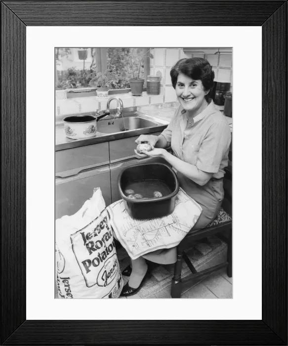 Framed Print : A housewife peeling spuds Framed Print : A housewife peeling spuds
