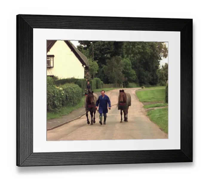 Framed Print : Man walking horses through the village of Offchurch in Warwickshire