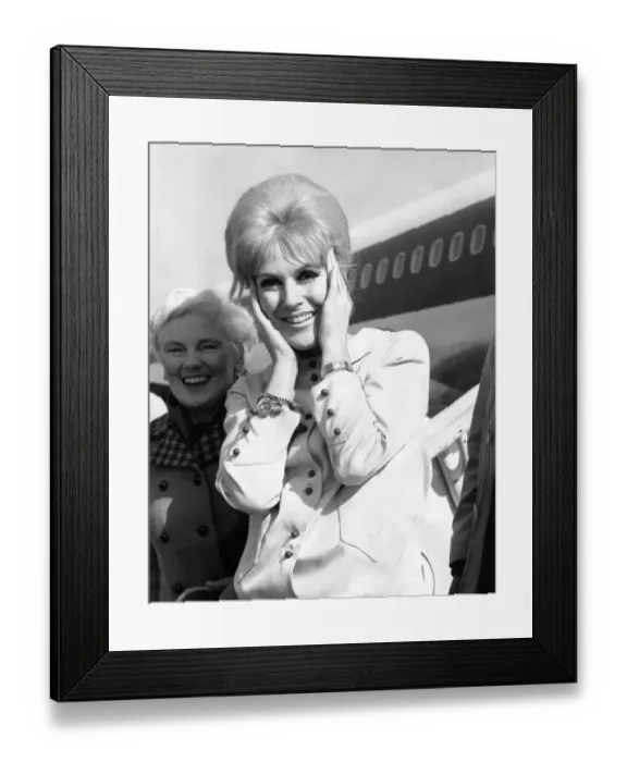 Framed Print : Singer Dusty Springfield holds her hair together on the tarmac of London Airport as she Framed Print : Singer Dusty Springfield holds her hair together on the tarmac of London Airport as she
