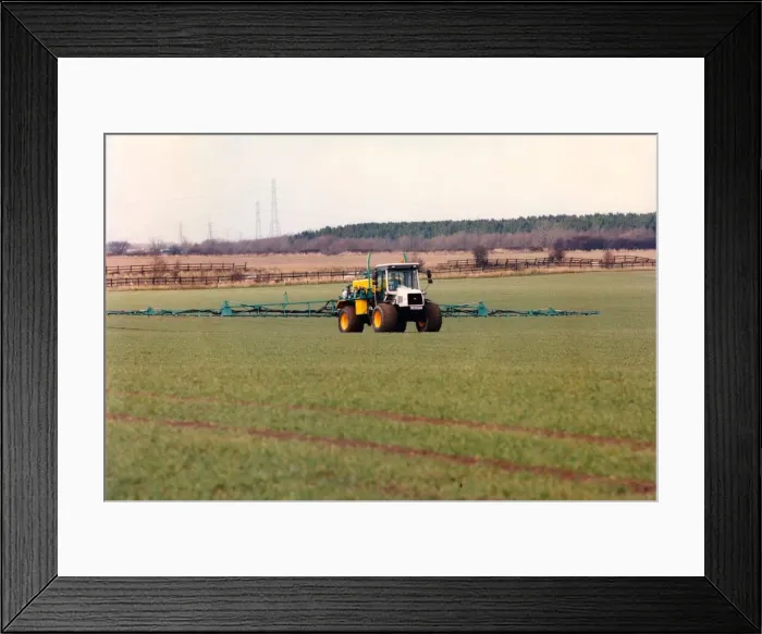 Framed Print : A farmer spraying his field with insecticide Framed Print : A farmer spraying his field with insecticide