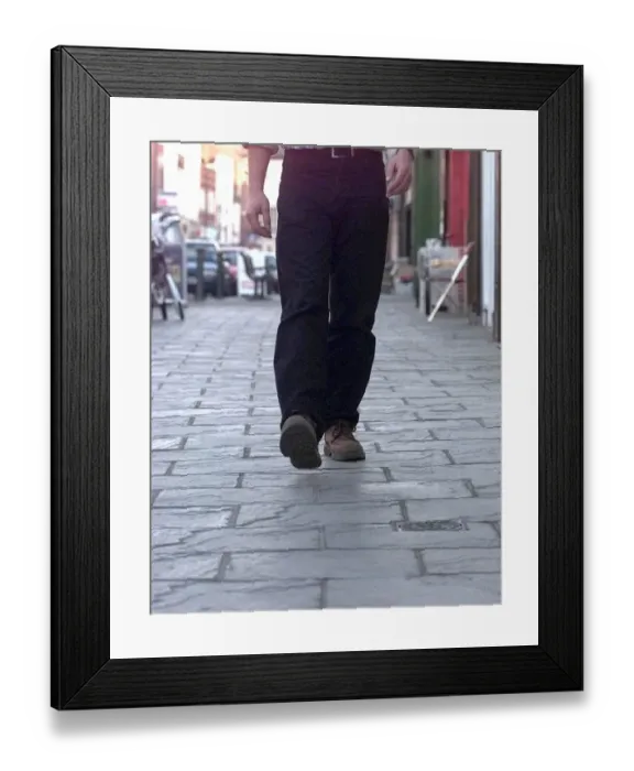 Framed Print : Tread carefully... a pedestrian walks along Long Street on the controversial cobbles in