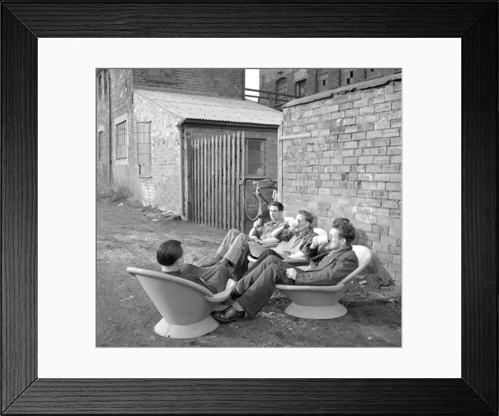 Framed Print : An alternative use for a hip bath. These workmen are using them as seats so they can Framed Print : An alternative use for a hip bath. These workmen are using them as seats so they can