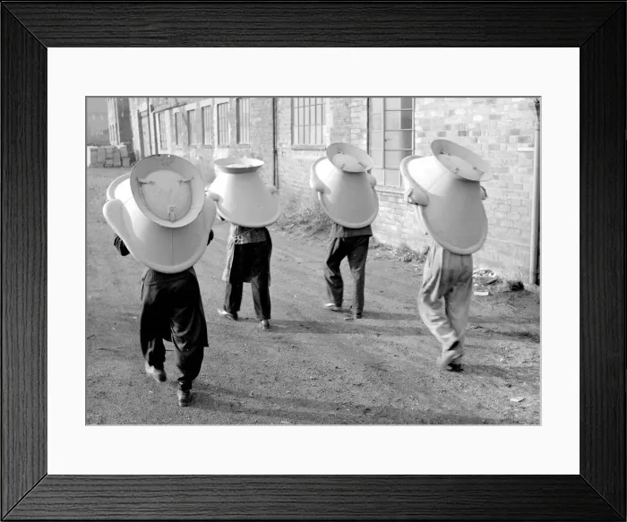 Framed Print : An alternative use for a hip bath. These workmen are using them as a hats during their Framed Print : An alternative use for a hip bath. These workmen are using them as a hats during their