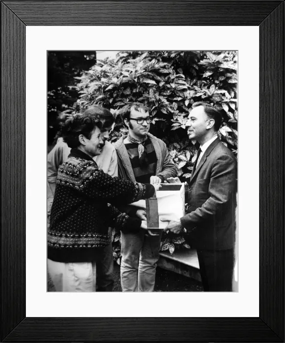 Framed Print : Pacifist campaigner Pat Arrowsmith ahands a biscuit tin full of collection money to Czech