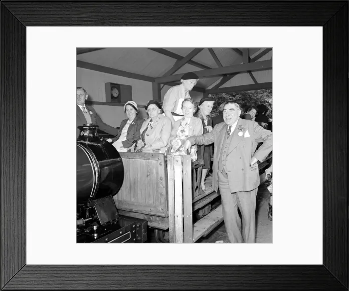 Framed Print : Pensioners on a day trip to Trentham Park prepare for a tour of the park on a model