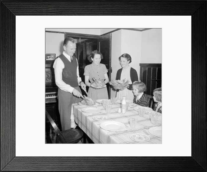Framed Print : Dad carves the chicken as mum and eldest daughter brings in the vegtables for lunch