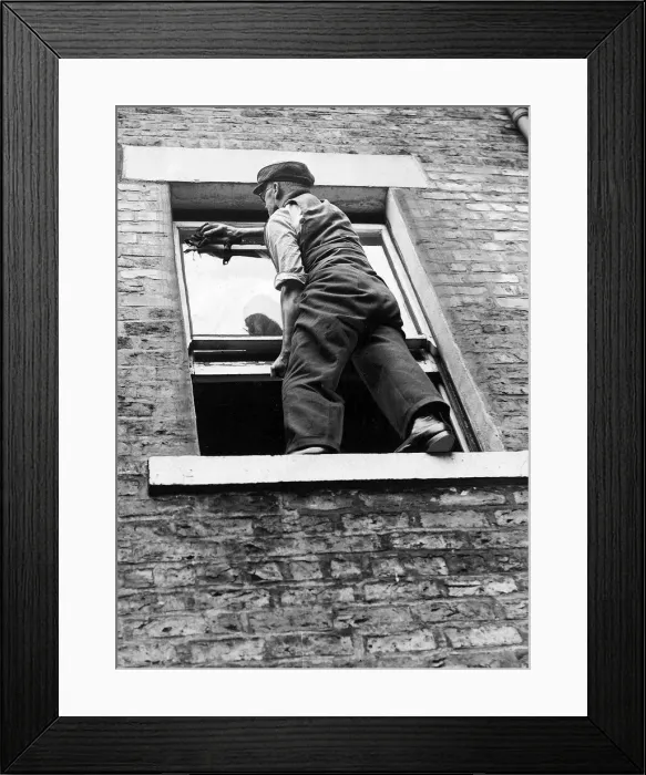 Framed Print : A worried householder understood that sitting on the sill to clean the windows was