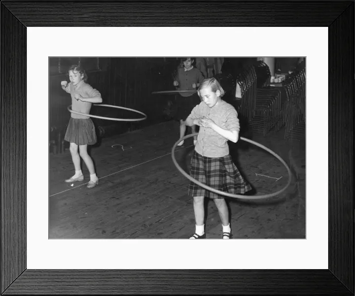 Framed Print : A pair of young girls during a hula hoop competition Framed Print : A pair of young girls during a hula hoop competition