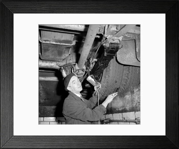 Framed Print : London Transport mechanics seen here checking the tyres of a Leyland bus Framed Print : London Transport mechanics seen here checking the tyres of a Leyland bus